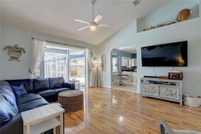 537 Ray St, Sebastian, FL 32958 - living room with ceiling fan, visible vents, arched walkways, vaulted ceiling, and wood finished floors