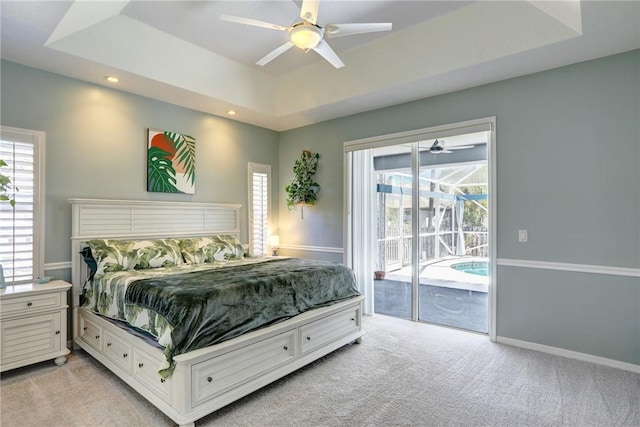 537 Ray St, Sebastian, FL 32958 - bedroom featuring access to outside, light carpet, a tray ceiling, and recessed lighting