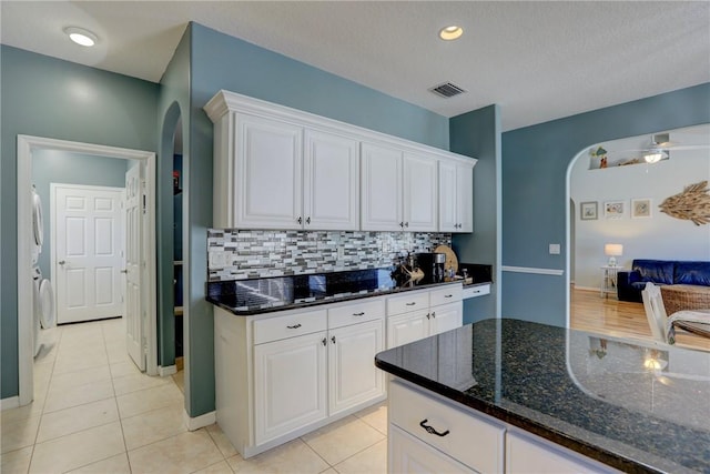 537 Ray St, Sebastian, FL 32958 - kitchen featuring white cabinets, arched walkways, and tasteful backsplash