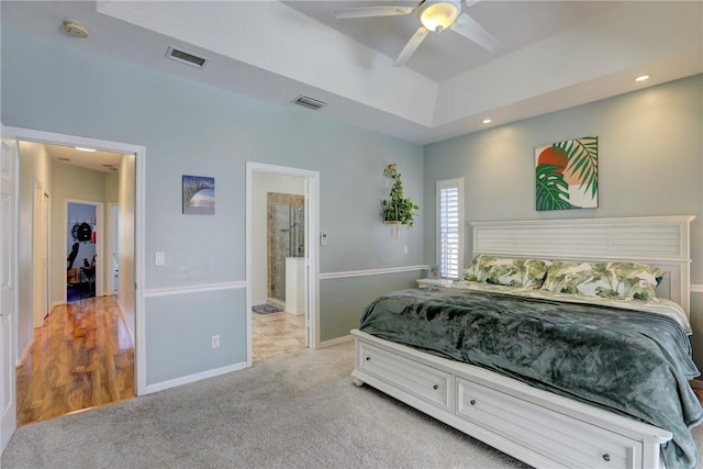 537 Ray St, Sebastian, FL 32958 - bedroom with baseboards, light carpet, a tray ceiling, and visible vents
