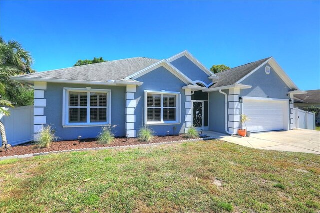 537 Ray St, Sebastian, FL 32958 - ranch-style house with a garage, fence, a front yard, and concrete driveway
