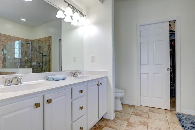 537 Ray St, Sebastian, FL 32958 - full bath with a sink, double vanity, toilet, a spacious closet, and a stall shower