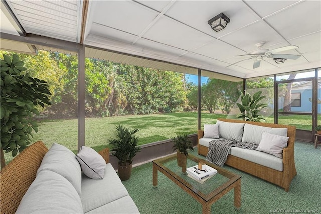 sunroom / solarium with ceiling fan and a drop ceiling