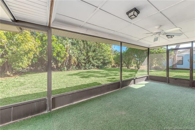 unfurnished sunroom featuring ceiling fan and a wealth of natural light