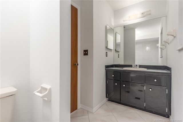 bathroom featuring toilet, tile patterned floors, and vanity