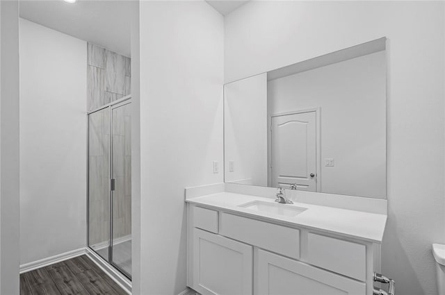 8425 98th Ct, Vero Beach, FL 32967 - bathroom with vanity, a shower stall, wood finished floors, toilet, and baseboards