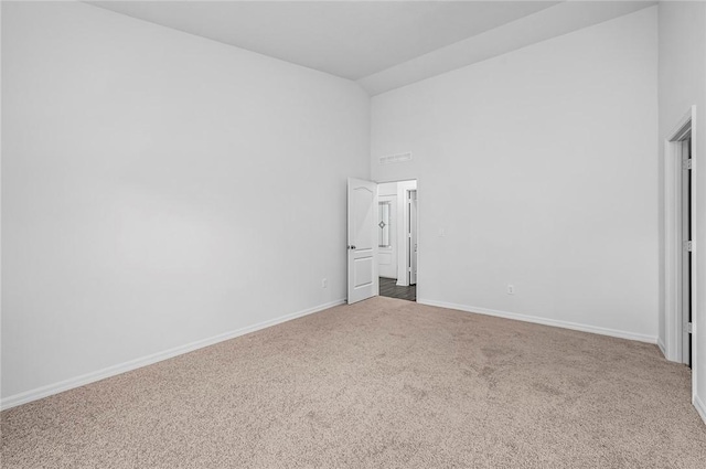 8425 98th Ct, Vero Beach, FL 32967 - unfurnished bedroom featuring carpet, high vaulted ceiling, and baseboards