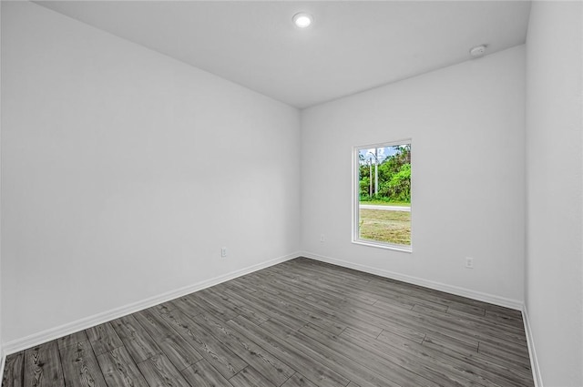 8425 98th Ct, Vero Beach, FL 32967 - empty room with baseboards, dark wood-style flooring, and recessed lighting