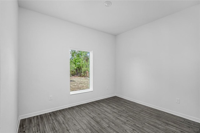 8425 98th Ct, Vero Beach, FL 32967 - spare room with dark wood-type flooring and baseboards