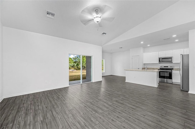 8425 98th Ct, Vero Beach, FL 32967 - unfurnished living room featuring a ceiling fan, dark wood-style floors, recessed lighting, high vaulted ceiling, and baseboards
