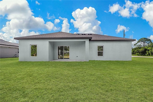 8425 98th Ct, Vero Beach, FL 32967 - rear view of property with a yard, stucco siding, a patio, and roof with shingles