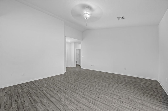 8425 98th Ct, Vero Beach, FL 32967 - spare room featuring a ceiling fan, wood finished floors, baseboards, and lofted ceiling