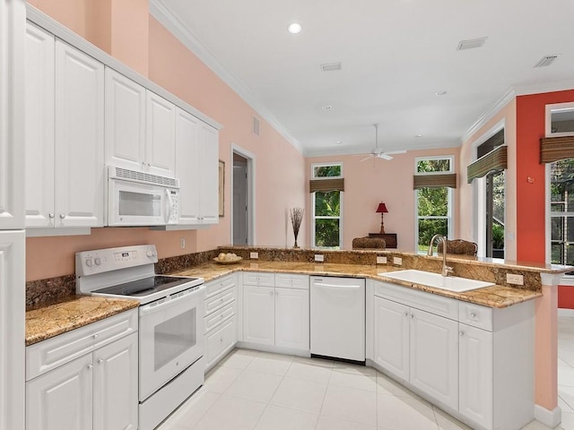 kitchen featuring kitchen peninsula, sink, white appliances, and white cabinetry