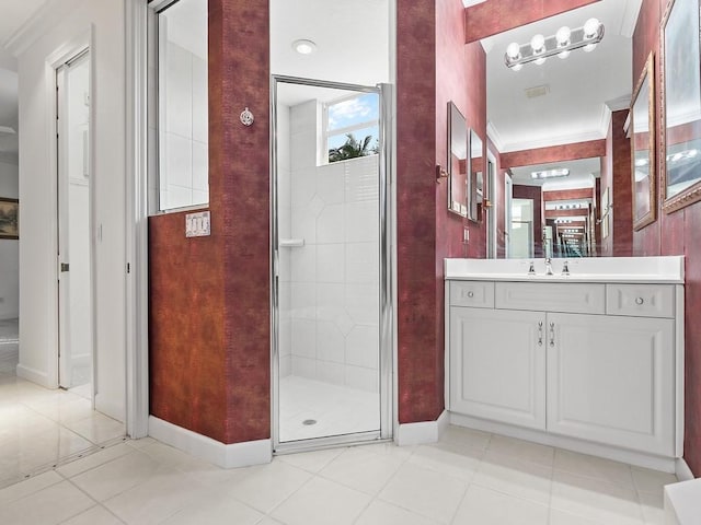 bathroom featuring a shower with shower door, vanity, tile patterned flooring, and crown molding