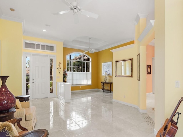 entrance foyer with ceiling fan and crown molding