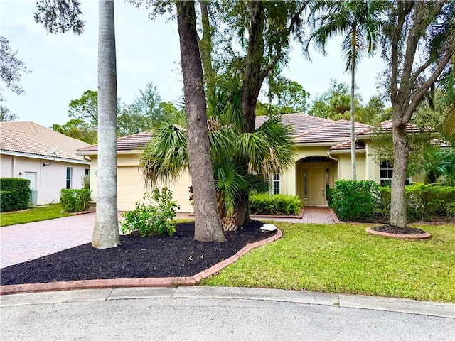 view of front of property with a front lawn and a garage