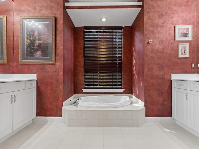 bathroom featuring vanity, tile patterned floors, and tiled tub