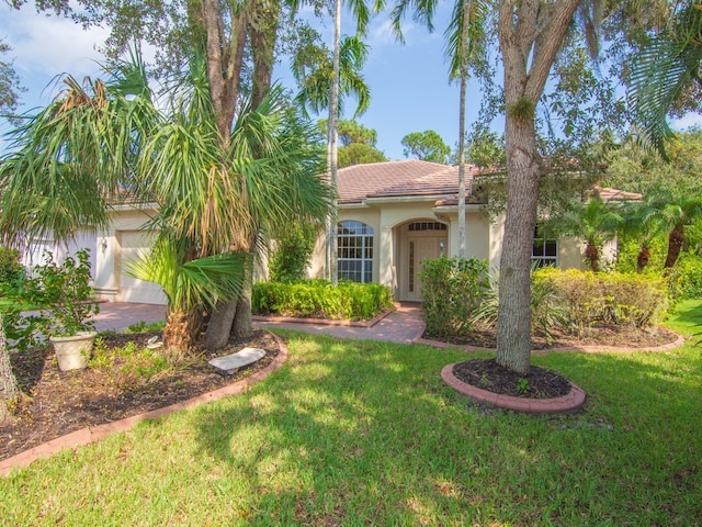 mediterranean / spanish home featuring a front yard