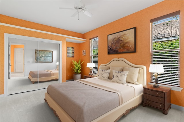 bedroom with ceiling fan, carpet, a closet, and multiple windows