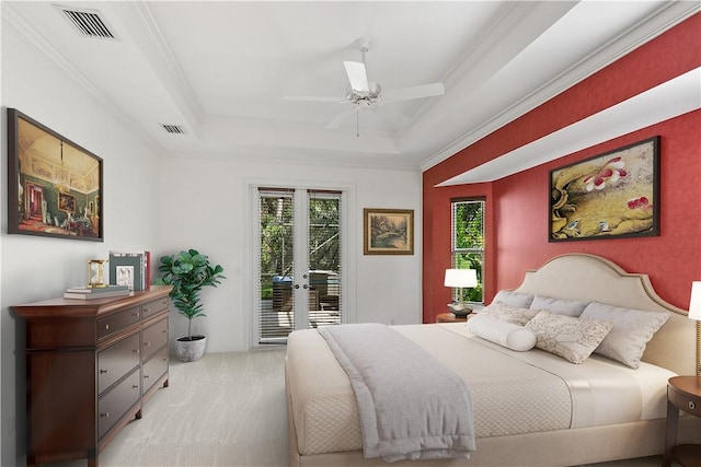 carpeted bedroom with ceiling fan, a raised ceiling, access to outside, french doors, and ornamental molding