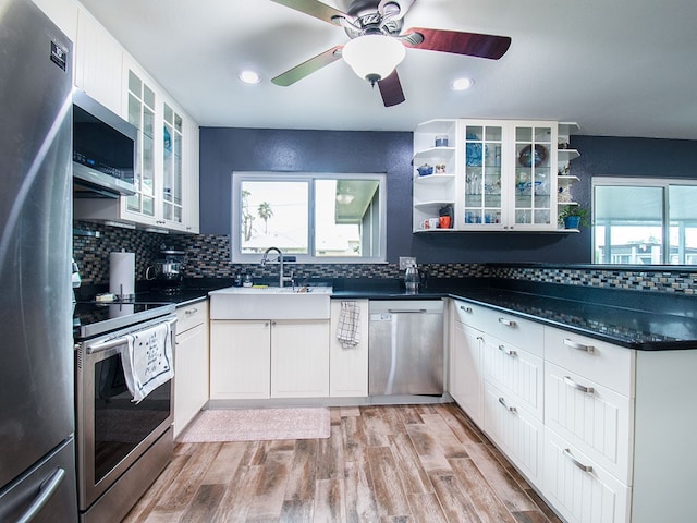 624 24th St SW, Vero Beach, FL 32962 - kitchen with stainless steel appliances, open shelves, ceiling fan, tasteful backsplash, and white cabinetry