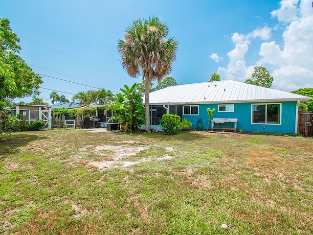 624 24th St SW, Vero Beach, FL 32962 - rear view of property with a metal roof, stucco siding, and a sunroom