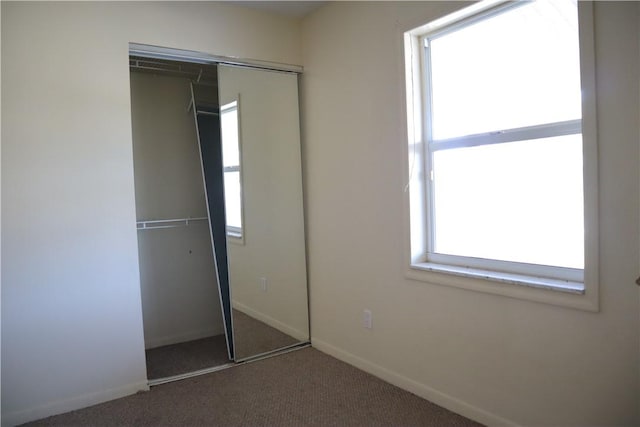 755 39th Ave, Vero Beach, FL 32968 - unfurnished bedroom featuring carpet, a closet, and baseboards