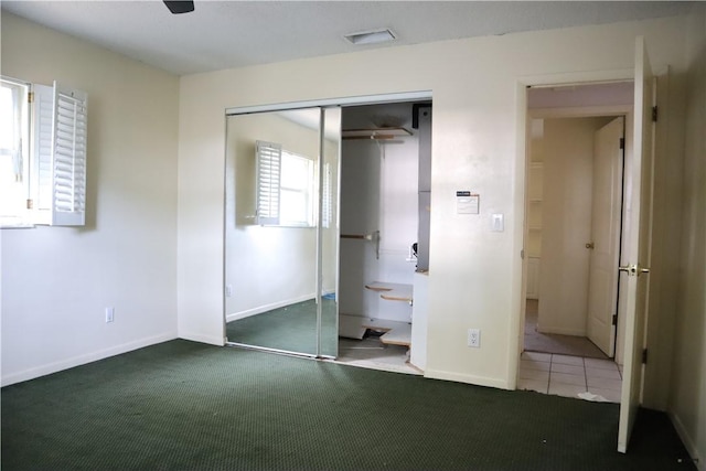 755 39th Ave, Vero Beach, FL 32968 - unfurnished bedroom featuring a closet, carpet floors, and baseboards