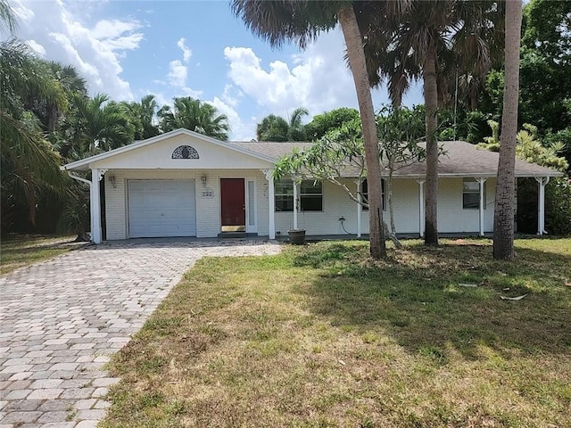 755 39th Ave, Vero Beach, FL 32968 - ranch-style home with brick siding, a front lawn, driveway, and a garage