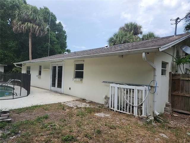 755 39th Ave, Vero Beach, FL 32968 - rear view of property with stucco siding, fence, a patio area, and french doors