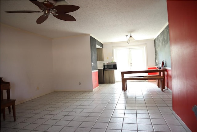 755 39th Ave, Vero Beach, FL 32968 - kitchen featuring stainless steel microwave, a ceiling fan, light tile patterned floors, a textured ceiling, and ornamental molding