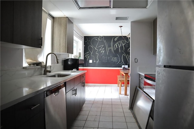 755 39th Ave, Vero Beach, FL 32968 - kitchen with stainless steel appliances, a sink, light countertops, light tile patterned floors, and modern cabinets