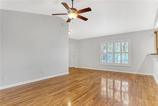 unfurnished living room featuring ceiling fan, light wood-type flooring, and vaulted ceiling