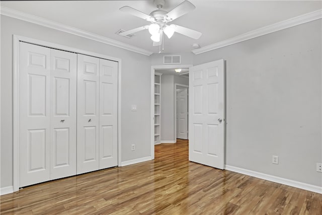 unfurnished bedroom featuring ornamental molding, a closet, light hardwood / wood-style floors, and ceiling fan