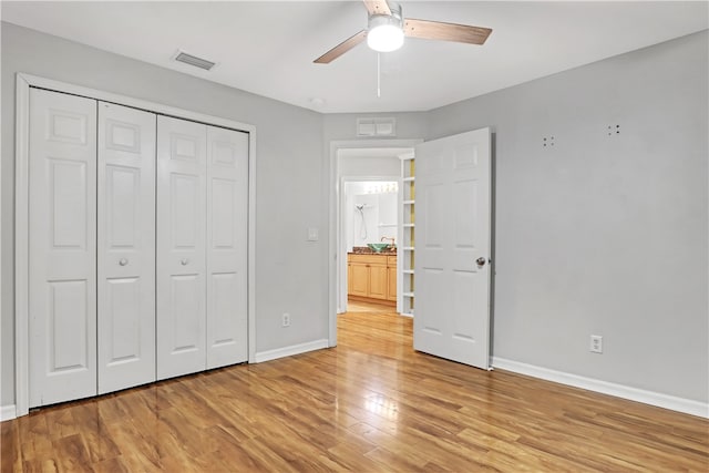 unfurnished bedroom with a closet, light wood-type flooring, and ceiling fan