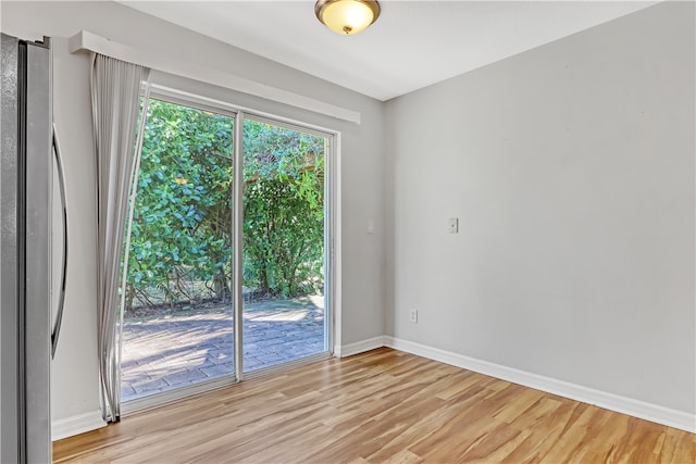 unfurnished room with light wood-type flooring