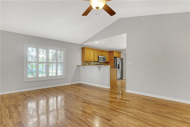 unfurnished living room with ceiling fan, lofted ceiling, and light hardwood / wood-style floors