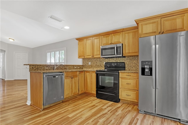 kitchen with stainless steel appliances, light wood-type flooring, backsplash, light stone countertops, and vaulted ceiling