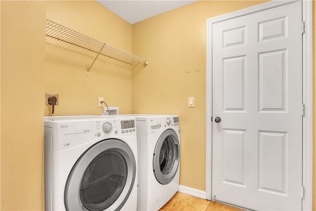 laundry room with light tile patterned floors and independent washer and dryer