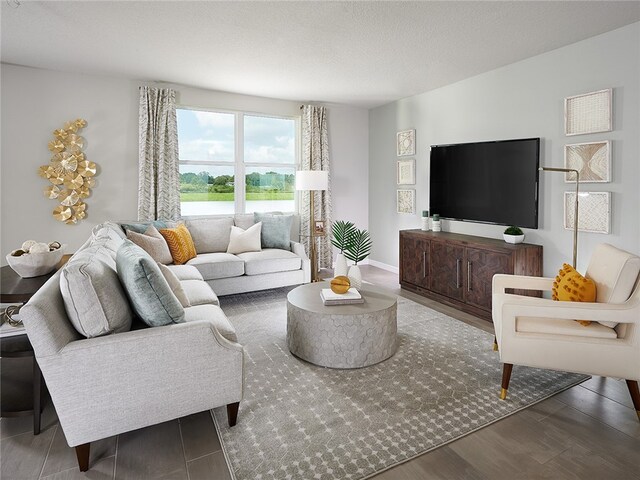 living room featuring wood-type flooring and a textured ceiling