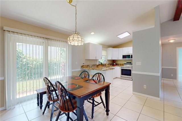 3405 Atlantic Blvd, Vero Beach, FL 32960 - dining room featuring plenty of natural light, lofted ceiling, light tile patterned floors, and baseboards