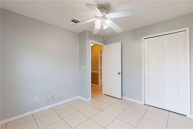 3405 Atlantic Blvd, Vero Beach, FL 32960 - unfurnished bedroom with light tile patterned flooring, baseboards, a closet, and a ceiling fan