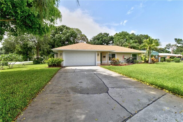 3405 Atlantic Blvd, Vero Beach, FL 32960 - ranch-style house featuring driveway, an attached garage, a front yard, and stucco siding