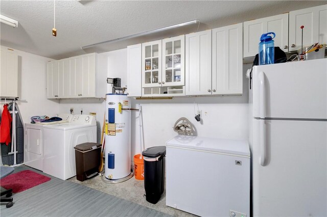 3405 Atlantic Blvd, Vero Beach, FL 32960 - washroom with separate washer and dryer, water heater, cabinet space, and a textured ceiling