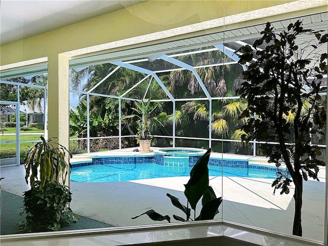 view of swimming pool with glass enclosure, an in ground hot tub, and a patio