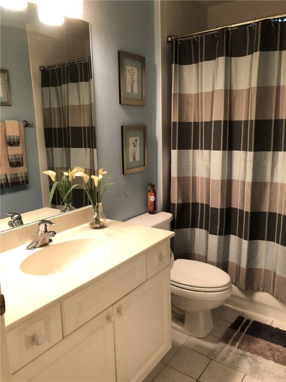 bathroom with tile patterned floors, vanity, and toilet