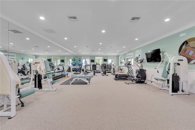 exercise room with light colored carpet and ornamental molding