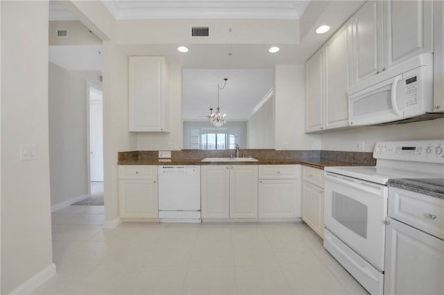 kitchen featuring white appliances, sink, ornamental molding, and white cabinets