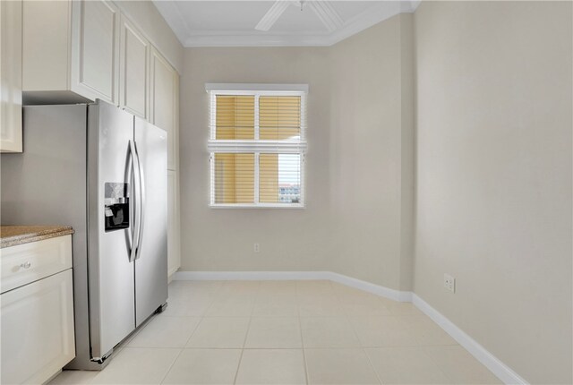 kitchen with white cabinetry, ornamental molding, ceiling fan, light tile patterned floors, and stainless steel fridge with ice dispenser