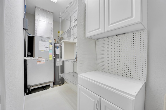 kitchen featuring white cabinets and heating unit